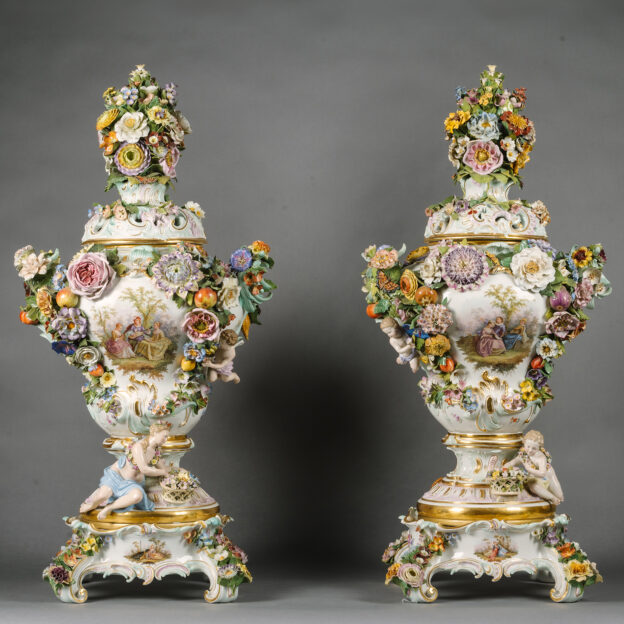 A Pair Of Large Meissen Porcelain Flower-Encrusted Pot-Pourri Vases and Covers On Stands.